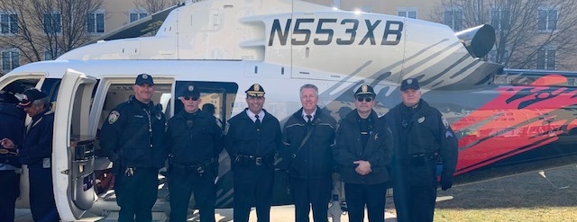 Officers with a N553XB helicopter.